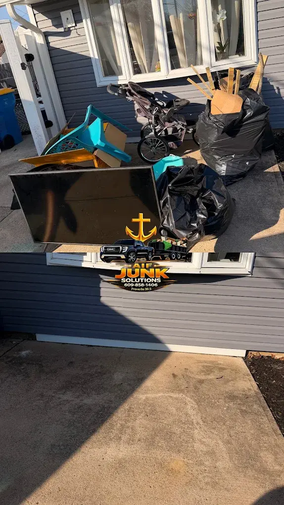 Furniture, boxes, and bagged junk cleared from a patio